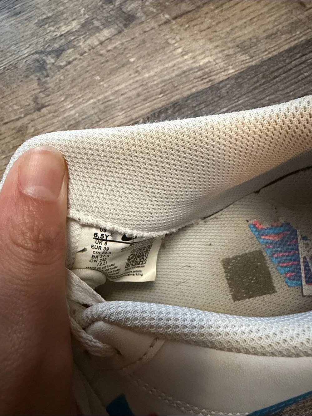 Nike White Low-Top Sneakers with Blue and Red Swoosh